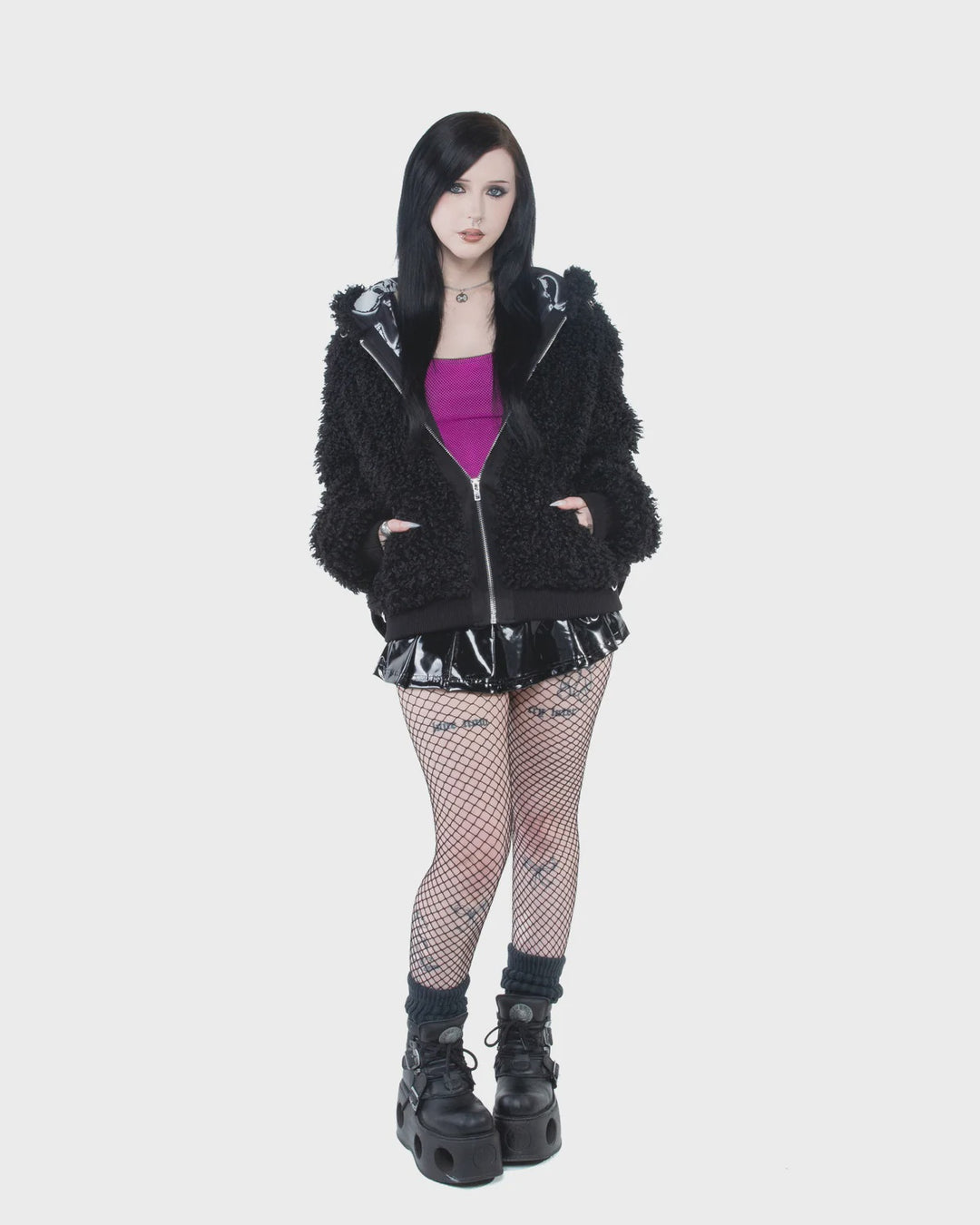 Model wearing the black Bleed Bomber Jacket with platform boots.