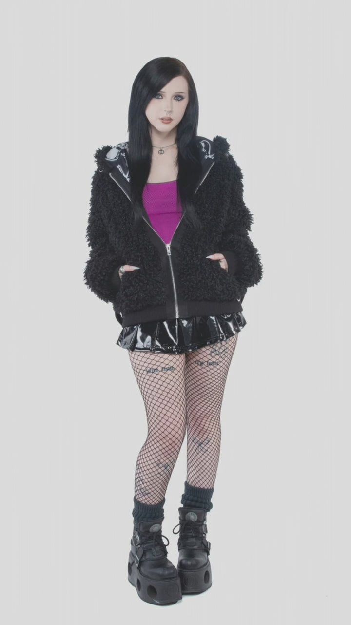 Model wearing the black Bleed Bomber Jacket with platform boots.